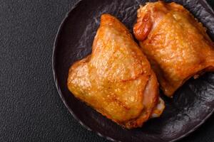 Chicken thighs fried with salt, spices and herbs photo