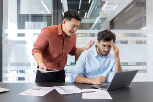 A business scenario depicting an angry boss confronting a stressed employee in a modern office setting. The scene highlights workplace conflict, stress, and communication issues between colleagues. photo
