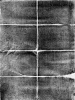 Grunge-style black and white folded paper texture with a distressed, rough appearance, perfect for backgrounds. photo