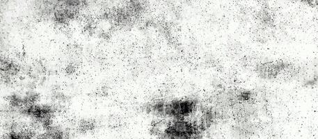 Light grunge texture with speckled noise and smudged patterns in black and white, ideal for backgrounds or overlays. photo