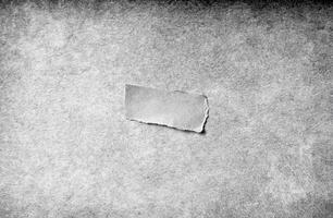 Close-up view of a grungy gray paper texture with rough details, ideal for use as a background or overlay. photo