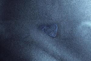 Blue metallic abstract texture with fine grainy details and a gradient effect, ideal for backgrounds or overlays. photo