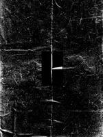 Grunge-style black and white texture featuring distressed edges, fold marks, and a weathered appearance. photo