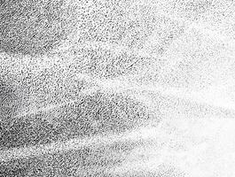 A high-contrast black and white grainy texture featuring soft light streaks, ideal for artistic backgrounds and design overlays. photo
