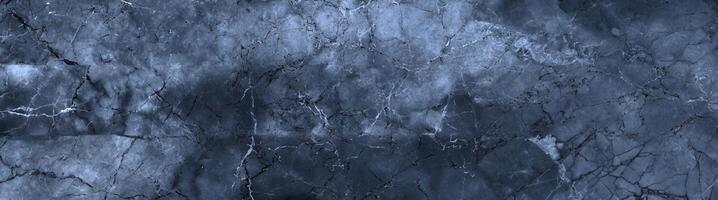Deep blue marble texture featuring organic cracks and natural stone patterns, perfect for backgrounds and design. photo