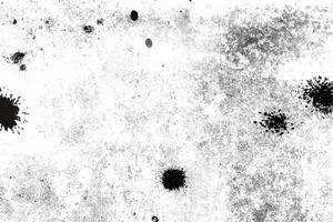 Abstract distressed texture with black speckles and rough patches on a white background, ideal for overlays or backgrounds. photo