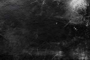 Dark grunge black texture with scratches and distressed elements, ideal for abstract backgrounds or overlays. photo