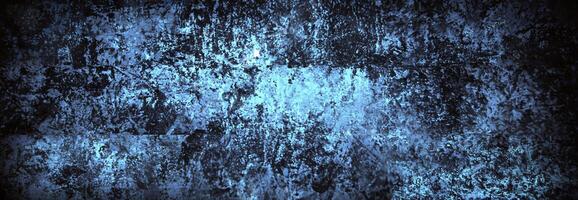 Abstract grunge texture featuring shades of blue and black, with a rugged and uneven surface pattern for backgrounds. photo