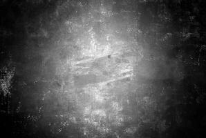 Abstract black and white grunge texture with a distressed, scratched surface, ideal for backgrounds and overlays. photo