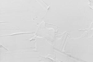 Texture of white plaster. Covering the concrete wall of the house. Rough surface. Repair and construction. photo