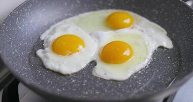 Sunny-side up eggs frying in pan video