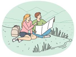 Happy couple of travelers sitting on lawn during hike in national park with lake and holding map vector