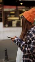 A Young Woman Happily Enjoying Reading a Text on Her Smartphone in an Urban Setting video