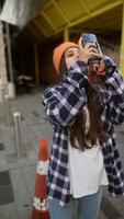 Engaging in Urban Exploration while using a camera and dressed in a trendy, stylish outfit video