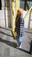 A Young Person Walking in an Urban Setting Surrounded by Unique Geometric Elements video
