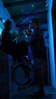 Engaging and Intimate Evening Conversation Illuminated by Vibrant Neon Lights and Colors video