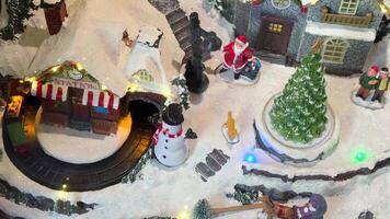 A Charming and Enchanting Winter Village Scene Featuring a Train Running and a Snowman Man video