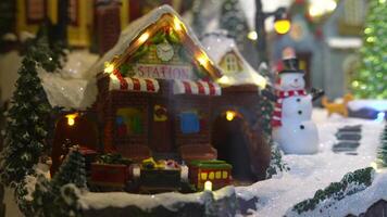 A Charming and Enchanting Winter Village Scene Featuring a Train Running and a Snowman Man video