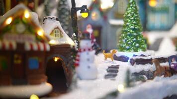 A Charming Winter Village Scene with a Snowman and Beautifully Festive Lights Displayed All Around video