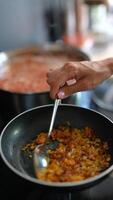 Cooking colorful vegetables in a pan with simmering sauce creates a flavorful, nutritious dish video
