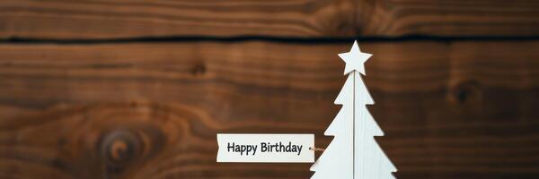 Birthday celebration with a decorative white tree against a rustic wooden background photo