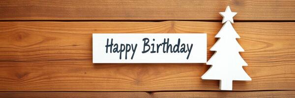 Celebrate a memorable birthday with a festive tree decoration and cheerful greeting on a wooden background photo