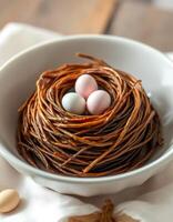 Decorative bird's nest with three eggs resting on a wooden table in a cozy setting photo