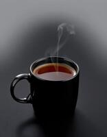 Steaming cup of coffee on a dark background creating a cozy atmosphere photo