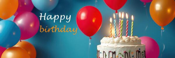 Colorful birthday celebration with cake, balloons, and candles creating a cheerful atmosphere photo