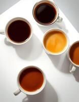 Various cups of coffee showcasing different shades and textures on a bright surface photo