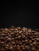 Freshly roasted coffee beans piled against a dark background highlighting their rich color and texture photo
