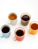 Variety of colorful coffee cups filled with different types of coffee on a plain background photo