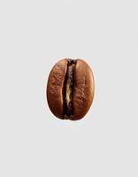 Close-up view of a single coffee bean, highlighting its unique texture and color for brewing enthusiasts and coffee lovers photo