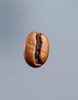 Brown coffee bean floating against a simple blue backdrop with subtle textures and patterns in the background photo