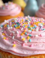 Colorful cupcakes with pink frosting and sprinkles displayed in a bright kitchen setting photo