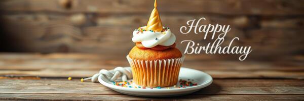 Delicious birthday cupcake decorated with colorful sprinkles and a cone on a rustic wooden table photo