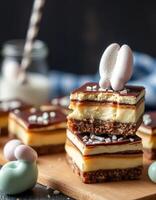 Decadent layered dessert with chocolate topping, creamy filling, and decorative meringues served on a wooden board photo