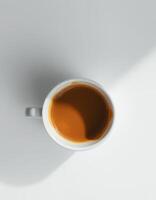 Hot beverage in white cup on light background with gentle shadow and warm tones at morning photo