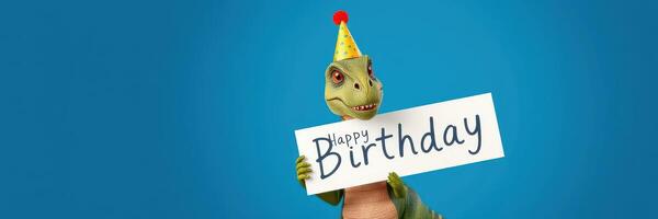 Colorful dinosaur with a birthday hat celebrating and holding a happy birthday sign indoors during a festive event photo