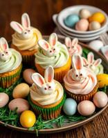 Colorful cupcakes decorated with bunny faces for an Easter celebration on a rustic wooden table photo