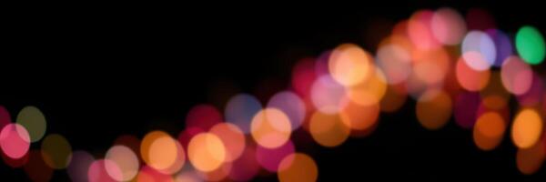 Colorful bokeh lights create a festive atmosphere during a nighttime celebration in a vibrant urban setting photo