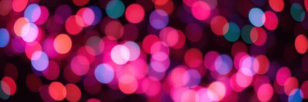 Colorful bokeh lights create a festive atmosphere during an evening celebration in a lively urban setting photo
