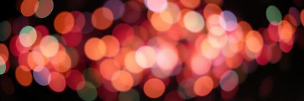 Colorful bokeh lights create a festive atmosphere during a nighttime celebration in an urban setting photo