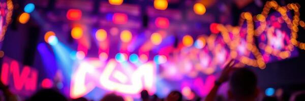 Colorful lights illuminate a vibrant concert atmosphere during a lively music event at night photo