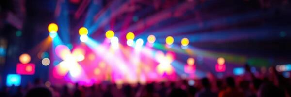 Colorful lights illuminate a vibrant concert atmosphere with cheering fans photo