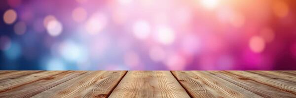 Wooden table against a colorful blurred background featuring shades of pink and blue in a festive atmosphere photo