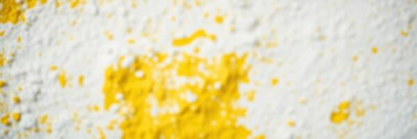 Bright yellow powder sprinkled on a white surface creating an artistic and textured visual element in a creative workspace photo