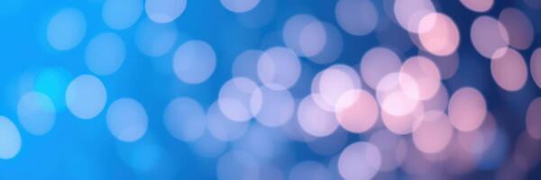 Colorful bokeh background with blue and pink lights creating an abstract festive atmosphere photo
