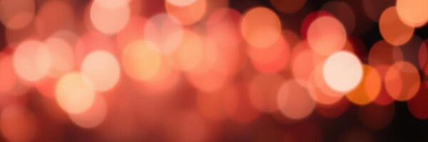 Vibrant bokeh effect with warm orange and red tones creating a festive atmosphere in a cozy setting photo