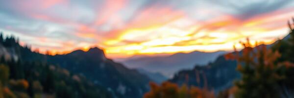 Vibrant sunset over a mountain landscape with soft clouds and warm colors filling the sky photo